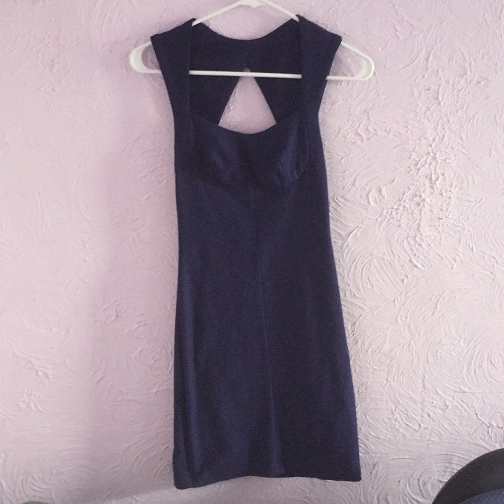Tight-fitting dark purple dress with open back